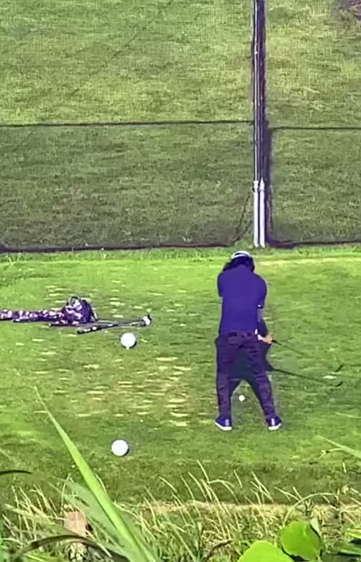 Golfer finishing a driver swing in a dramatic black-and-white scene